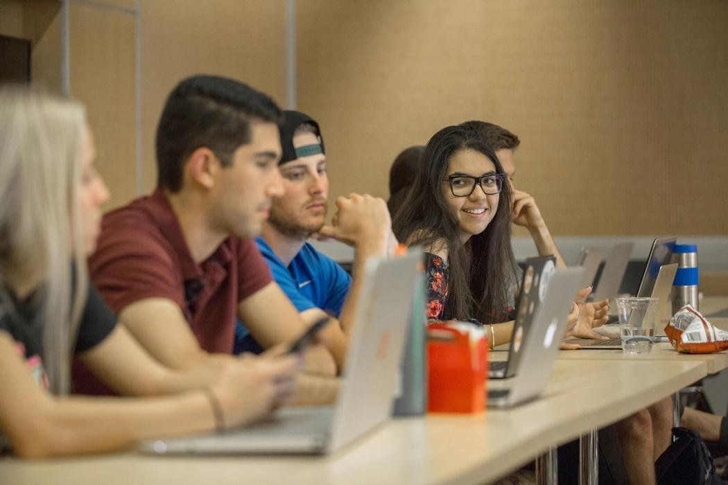 group of students in front of their laptops in class