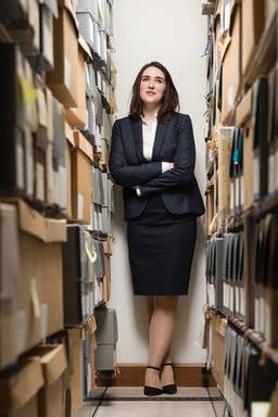 A study poses between the stacks of the Rollins College Archives.