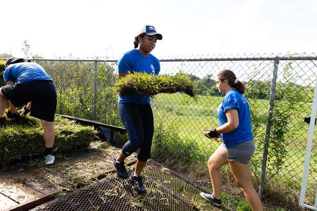 Liberal Arts college students helping to re-sod a park for Sparc Day.
