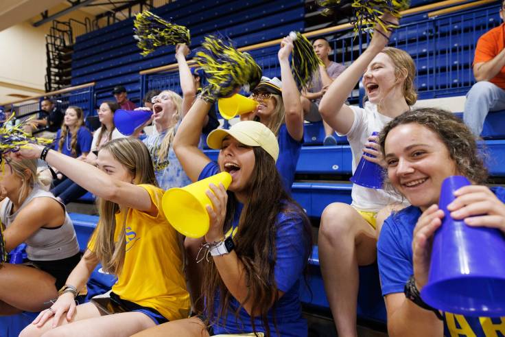 Group of Rollins students cheering on College Colors Day