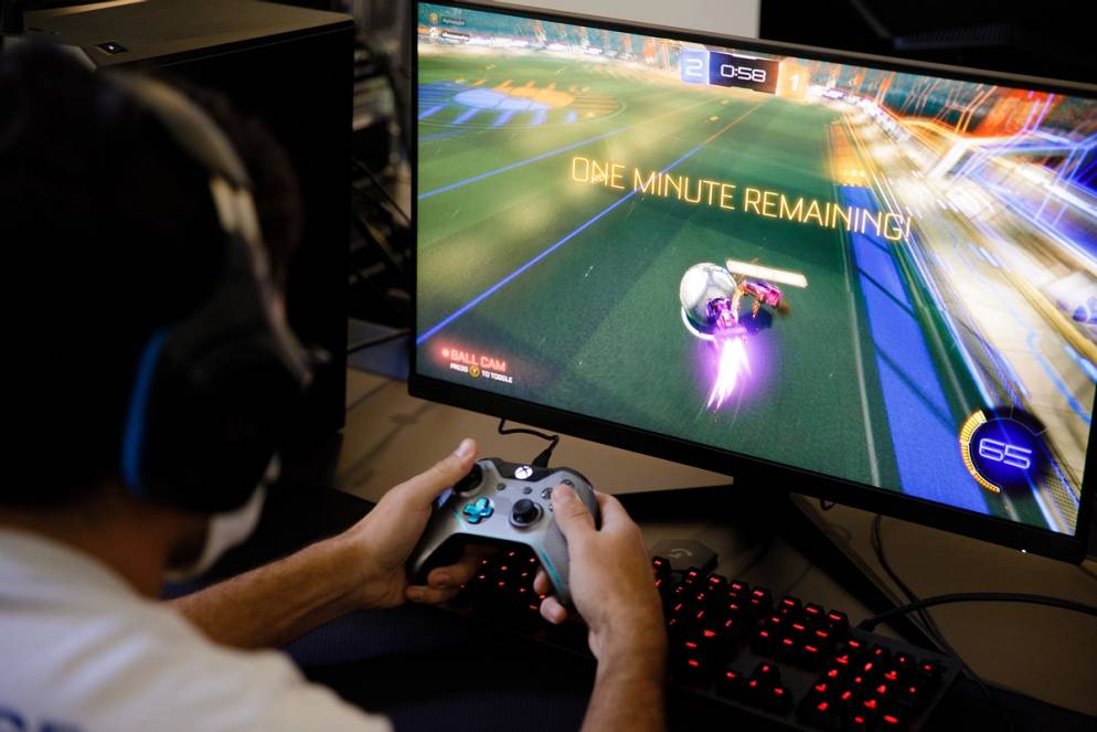 Student playing a video game in Rollins’ esports room.