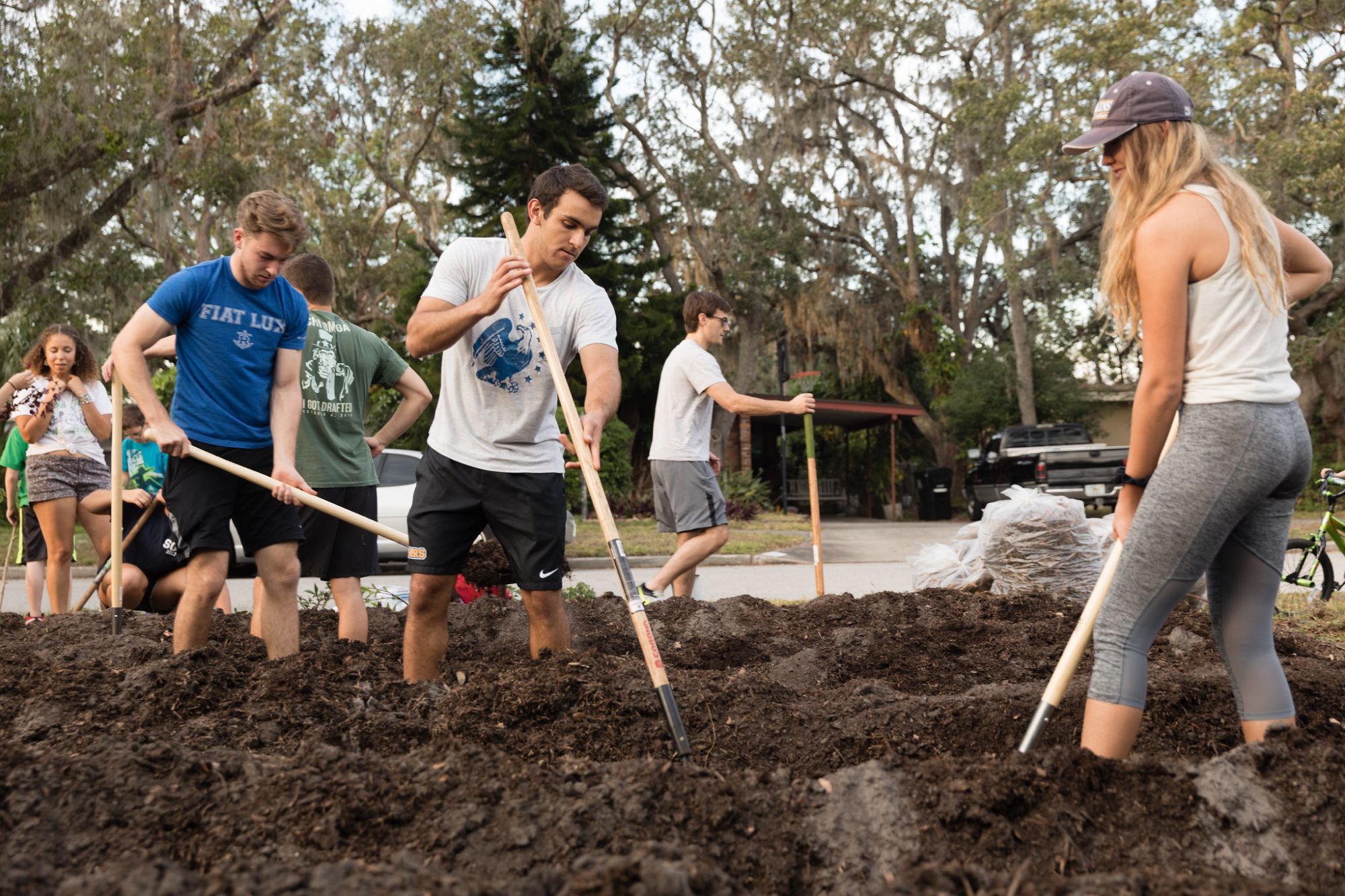 Students prepare a micro-farm in a residential lawn.