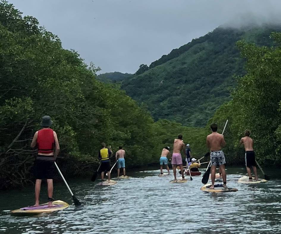 A group of Rollins College students kayaking along a river in Brazil.