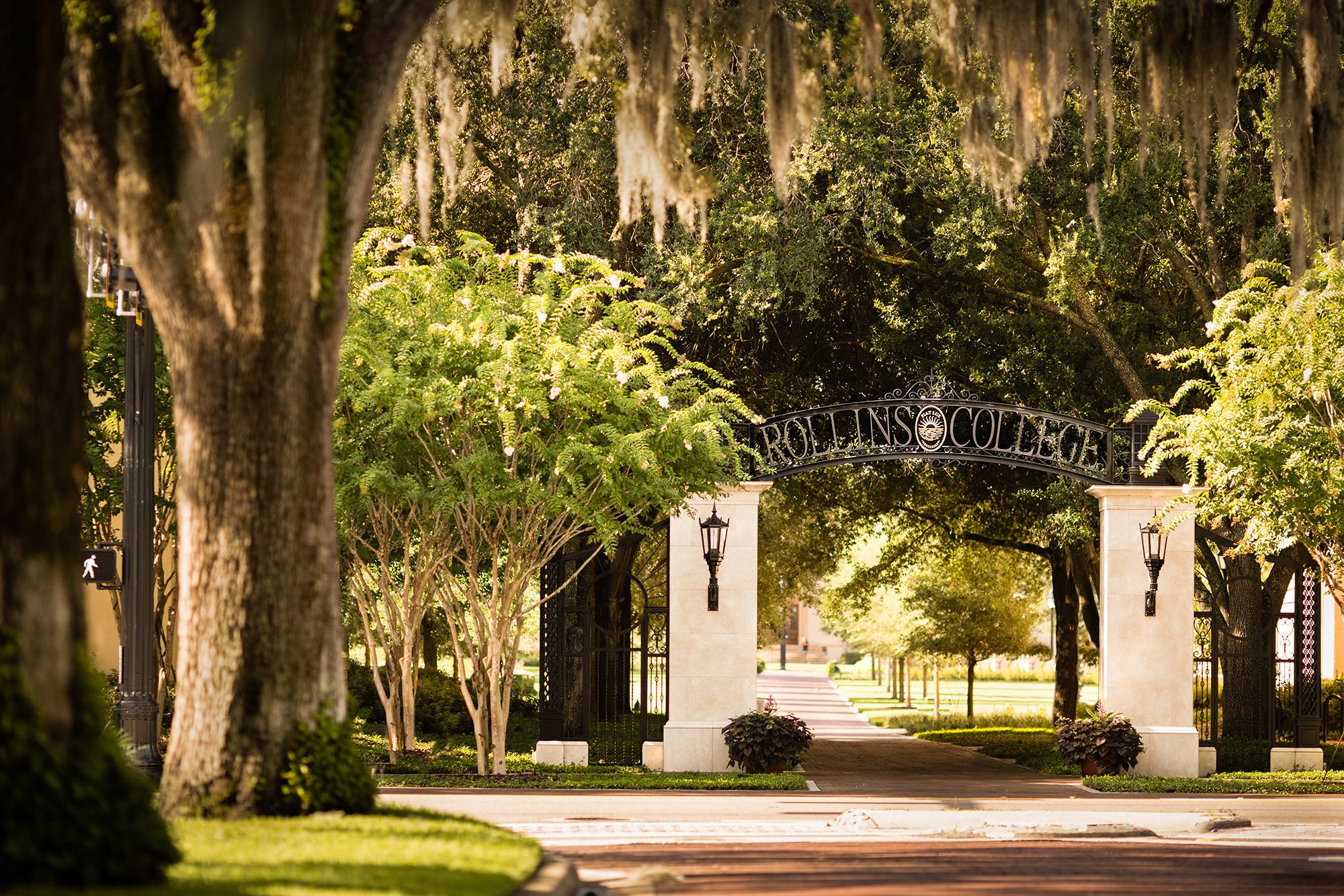 An arch marks the main entrance to the Rollins College campus.