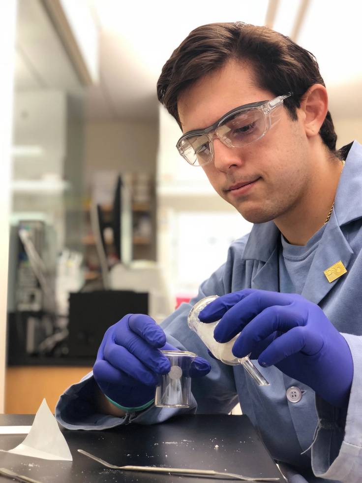 A chemistry student conducts research in a lab.