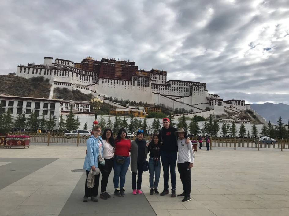 A group of Rollins College students post in front of a monument in China.