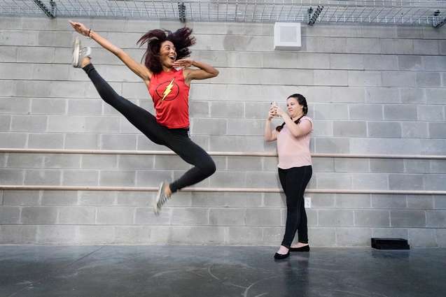 An alumn jumping at an internship for Orlando Ballet.