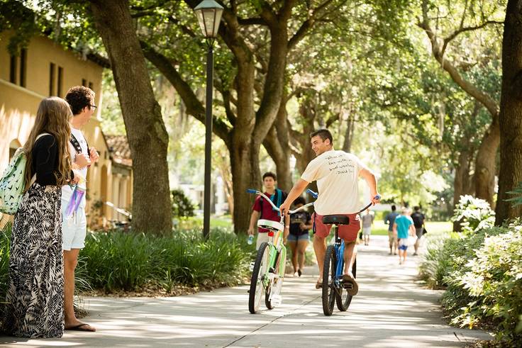 A Rollins student participating in the bike-share program on campus.