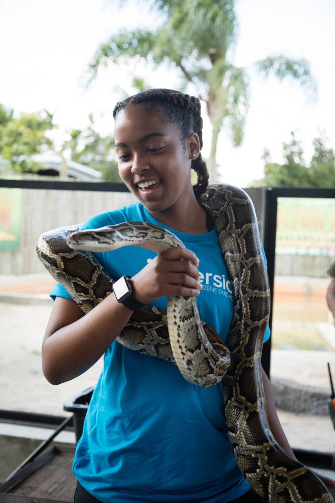 Student holds a snake on an Immersion experience in the Everglades.