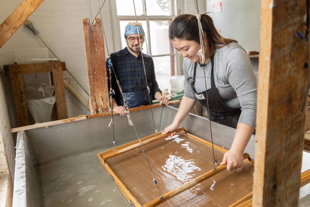 A Rollins alumni making paper in an art studio.