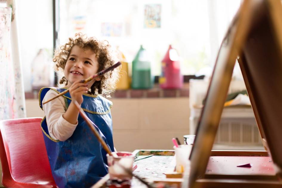 Child painting at an easel