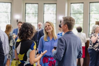 President Barnett during a welcome reception having a conversation with members of the Rollins community.