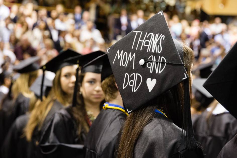 A Rollins college students sits at commencement.