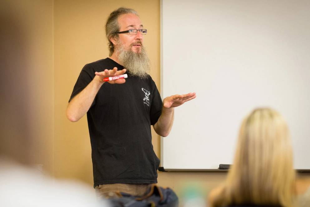 Professor, Phil Kozel, standing and addressing his class.