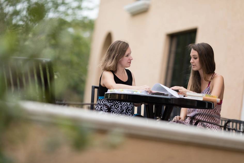 A faculty advisor works one on one with a college student.