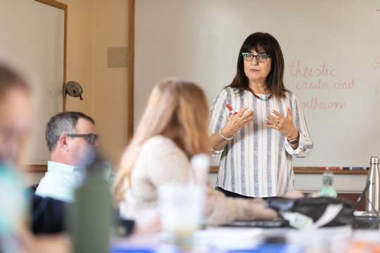 A Jewish Studies professor leads a classroom discussion with a small group of students.