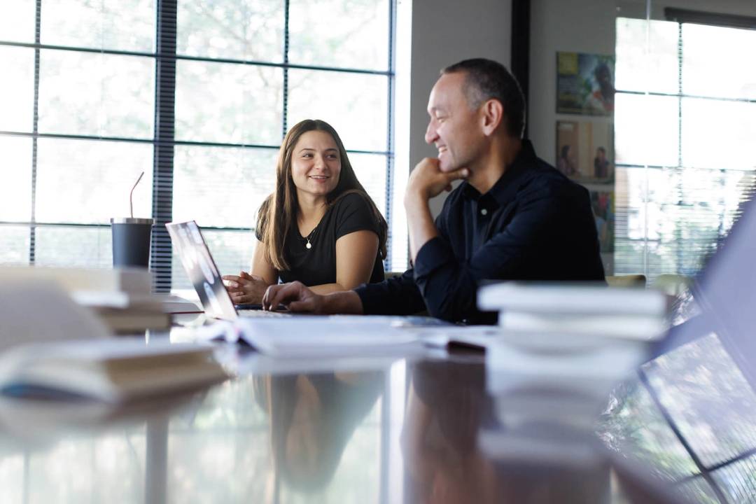 A college student meets one on one with her faculty advisor.