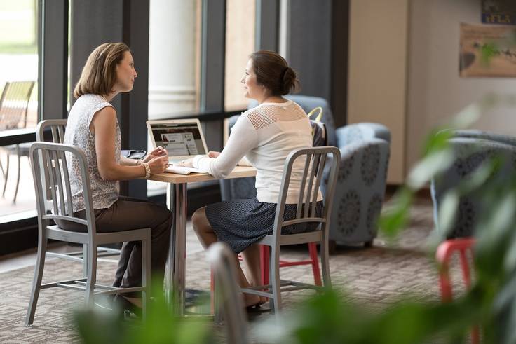 A professor chats with a Rollins student
