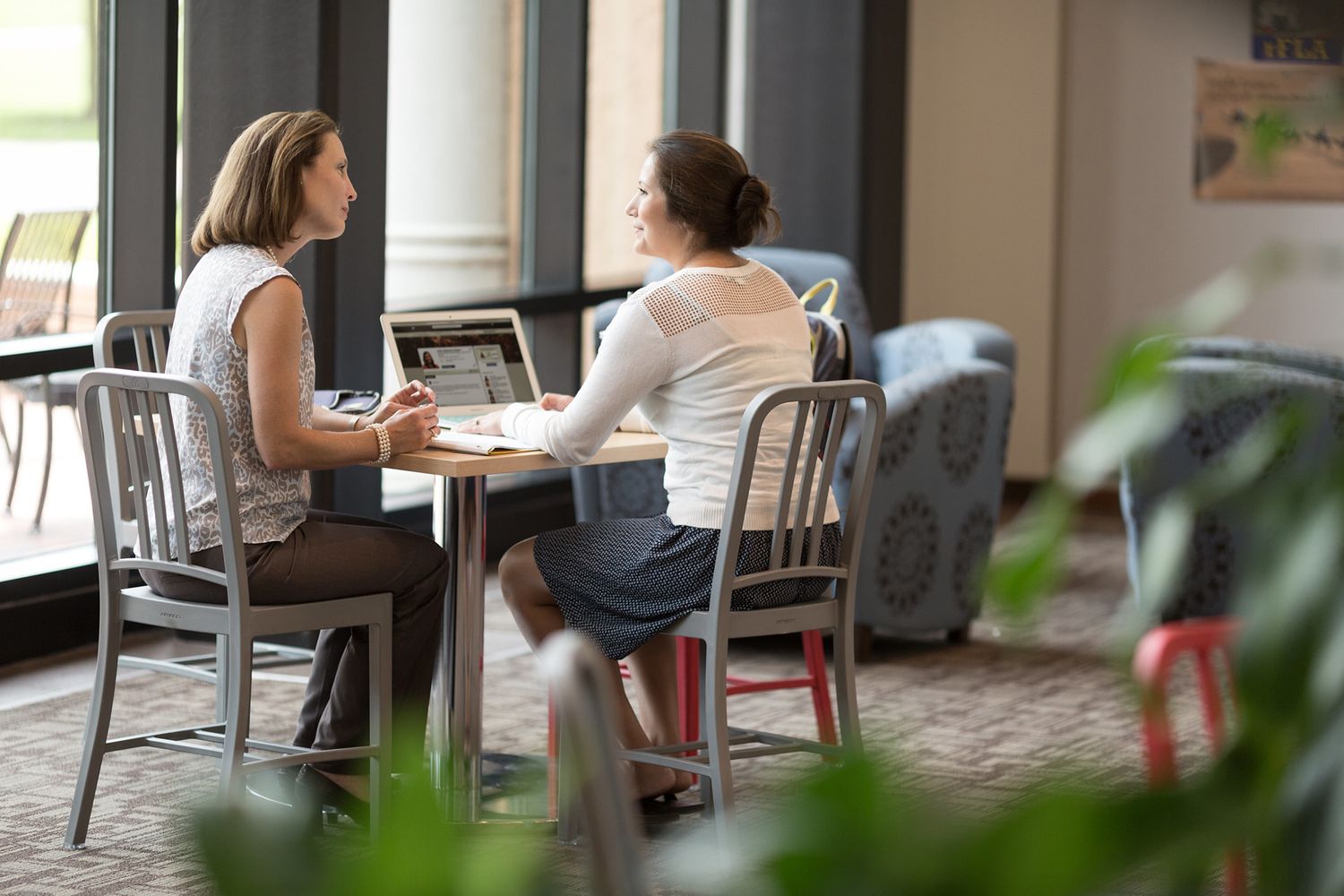 A professor chats with a Rollins student