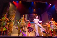 Students dance during a musical on the Annie Russell Theatre stage.