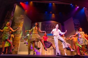 Students dance during a musical on the Annie Russell Theatre stage.
