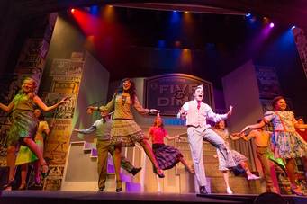 Students dance during a musical on the Annie Russell Theatre stage. 