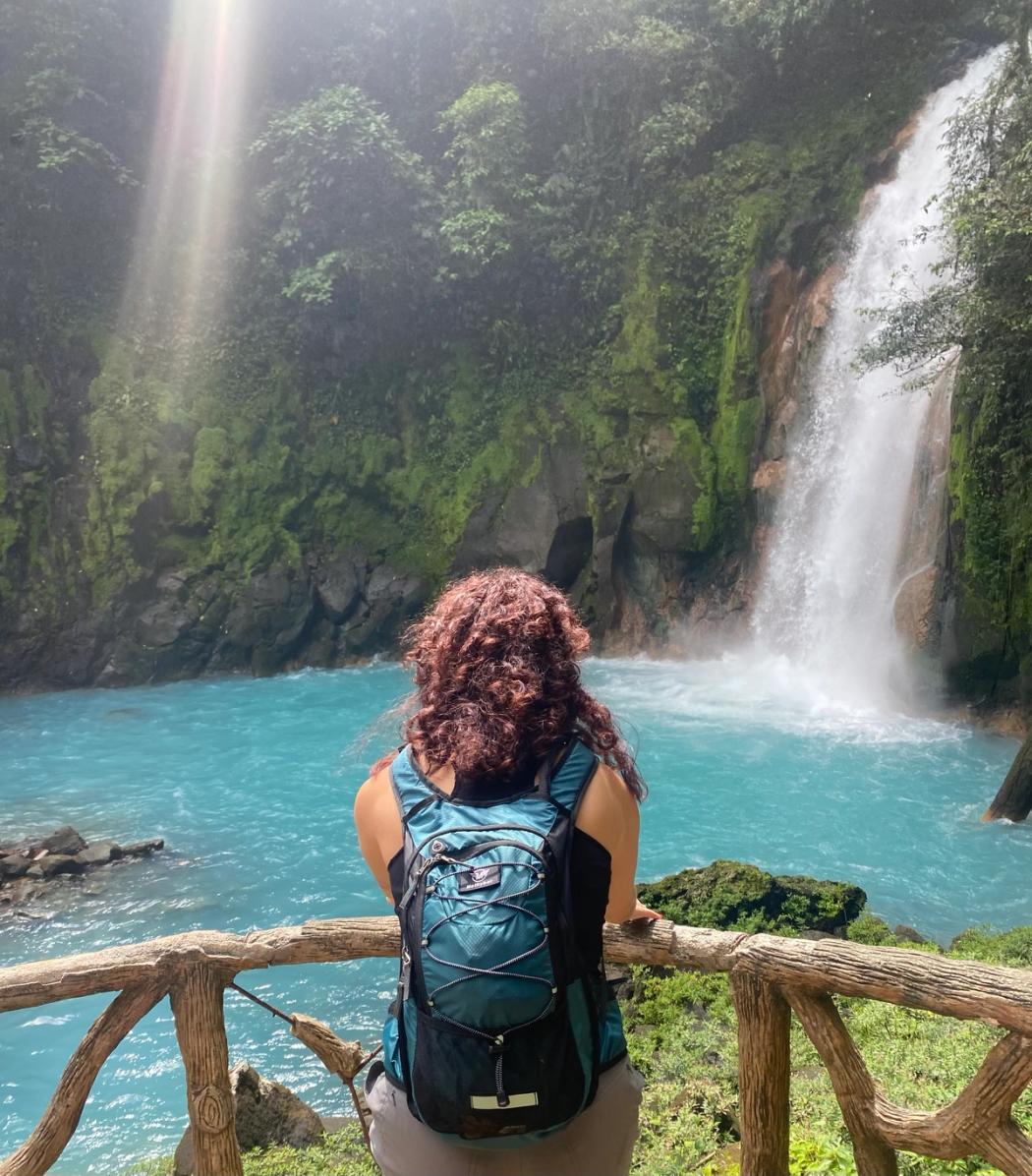 A Rollins College student enjoys a water fall in Costa Rica.