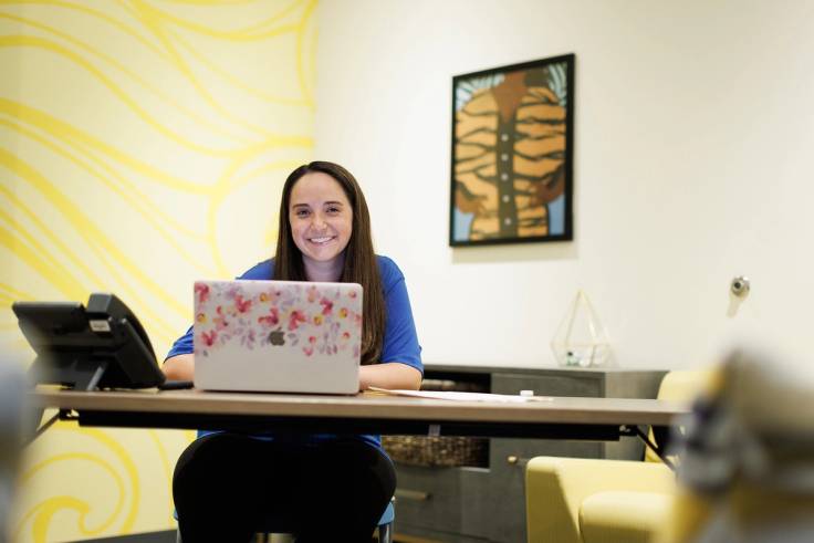 A Rollins student works on a laptop.