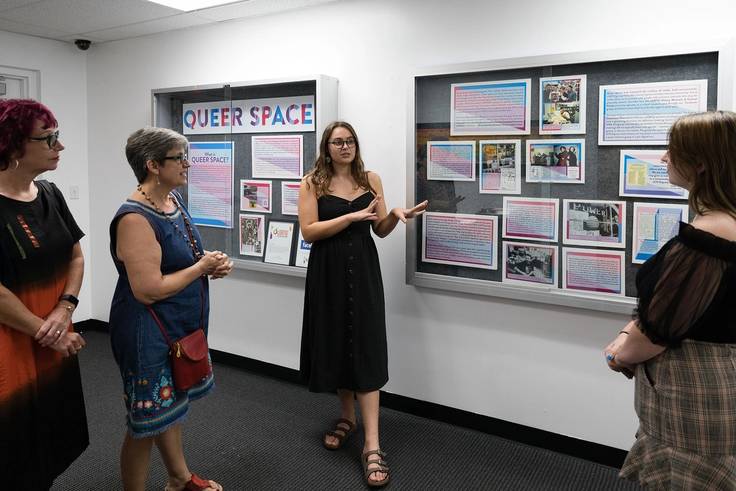 A student presents a curated exhibit at the LGBTQ history center