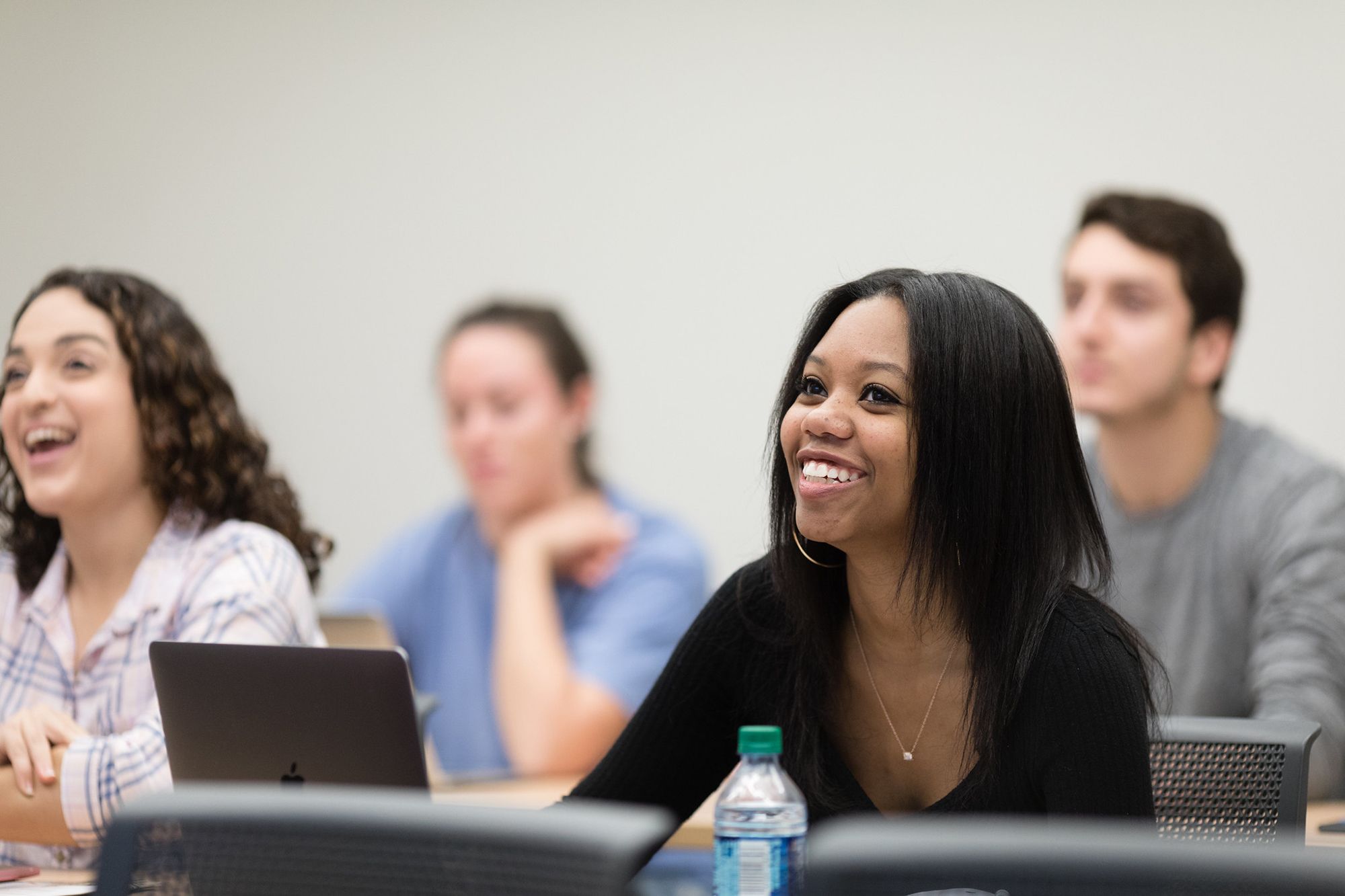 A student smiles during a communication studies course.