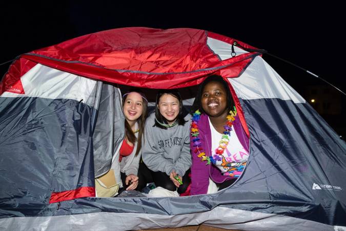 Rollins students pitch a tent for Fox Day celebrations on campus.