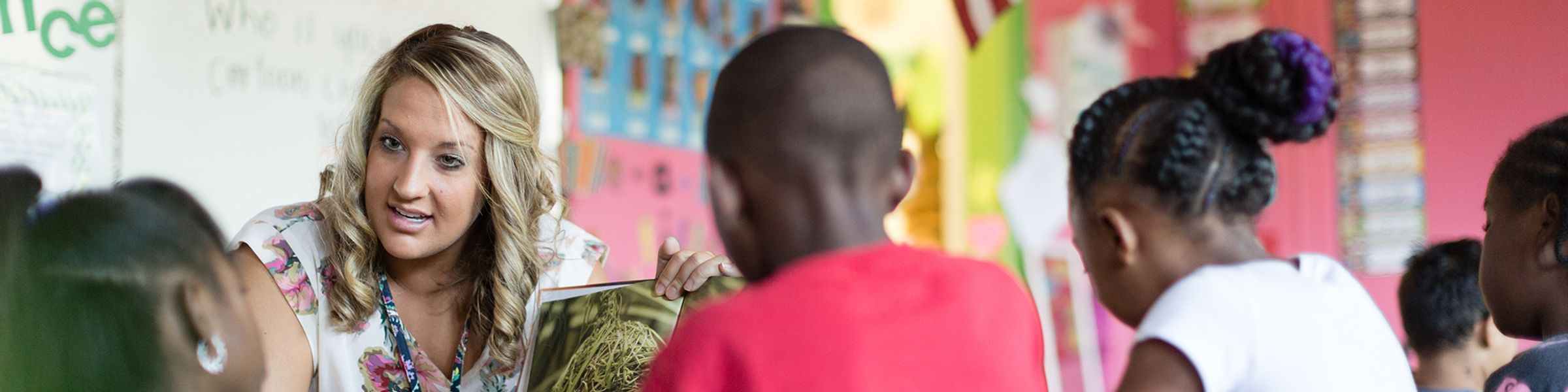 A teacher works with a small group of elementary school students.