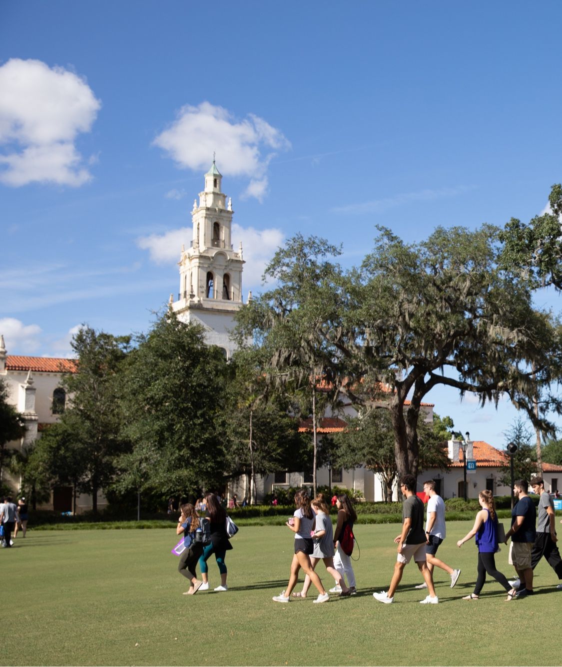 Five Rollins first-year students smile at the camera during an orientation event.