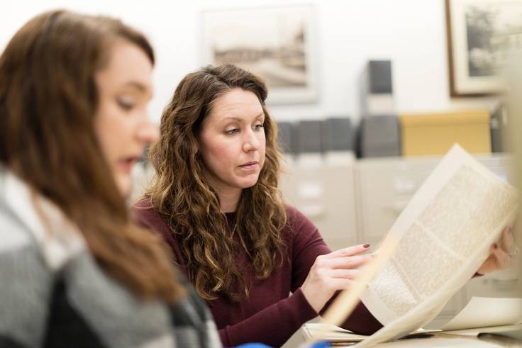 Digital archivist and records manager Rachel Walton works with a student in the Rollins College Archives.