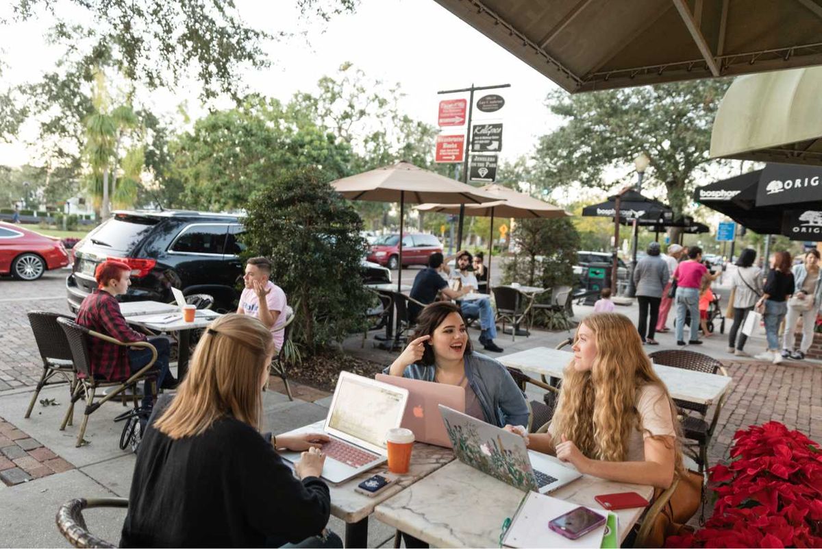 Rollins students work on their laptops at a café on Park Avenue.