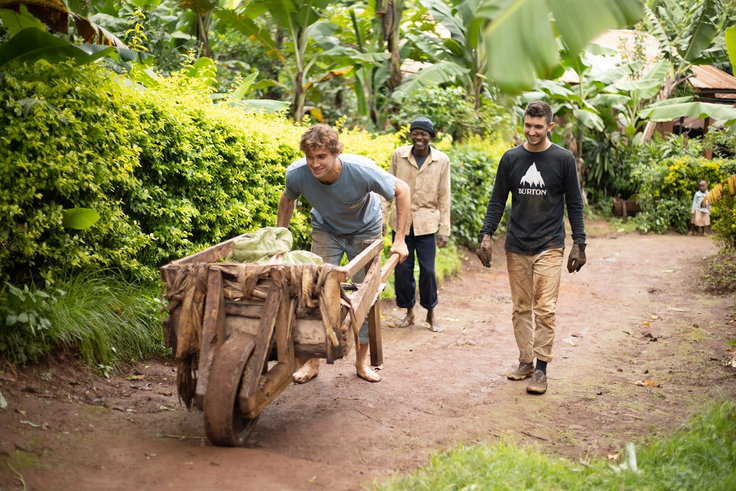 Student pushing a wheelbarrow up an incline in the village of Mkyashi, Tanzania.