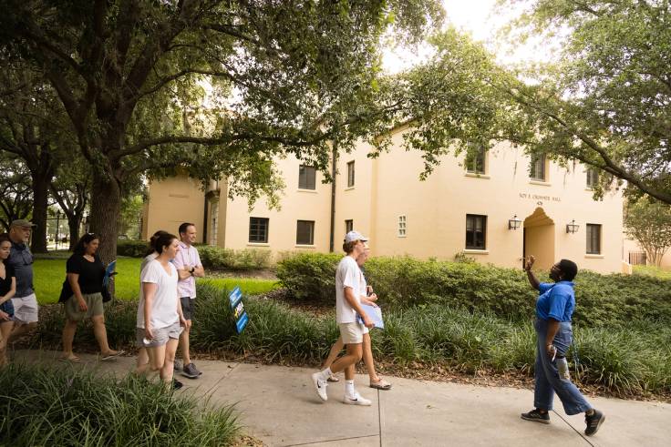 A tour guide leads people through the 91 campus.