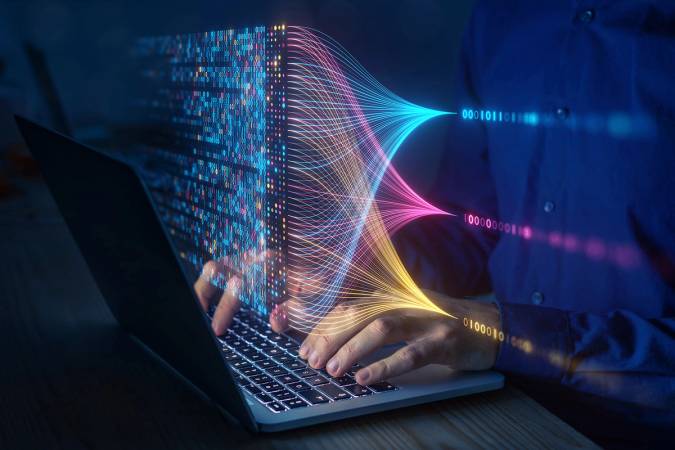 A person works on a data analytics project on their laptop.