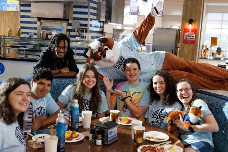 A costumed Fox celebrates Fox Day with students in Skillman Dining Hall.