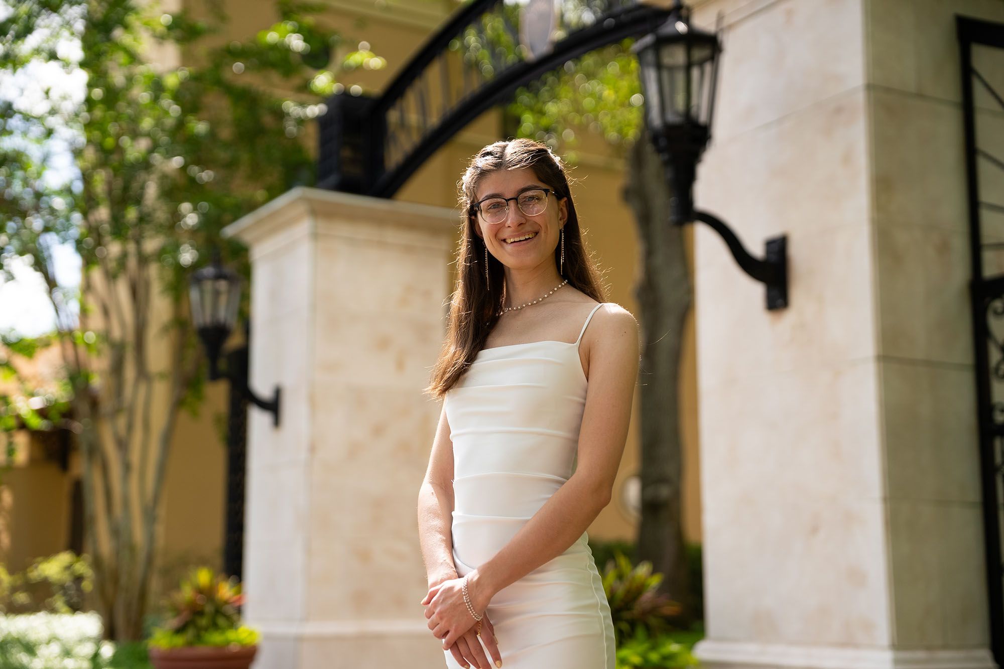 Emily Reynolds posing in front of the Rollins archway