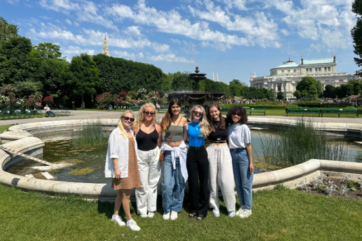 A group of Rollins College students pose in front of a park in Austria.