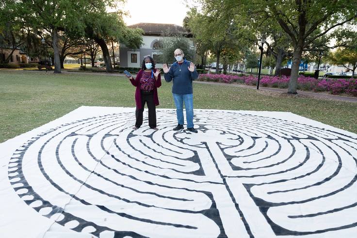 Rev. Katrina Jenkins and Frank Faine, project coordinator of Rollins’ new labyrinth, roll out the canvas labyrinth for “Fiat Lux: An Evening of Remembrance and Hope,” greatly anticipating the arrival of the permanent space this fall.
