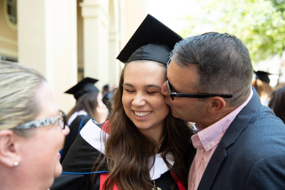 A student and their parent after graduation.