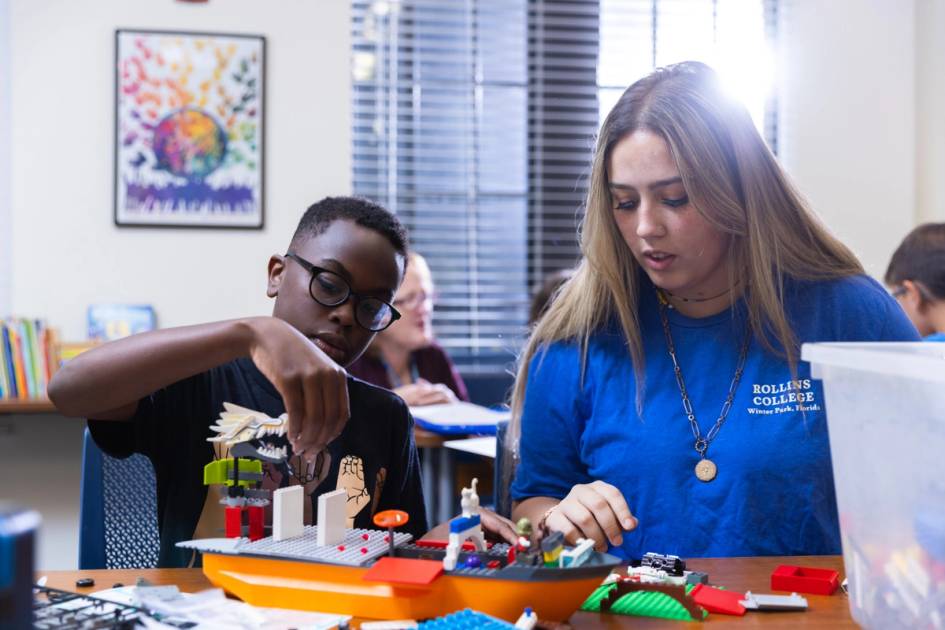Child building legos with a staff member of the EduCare program.