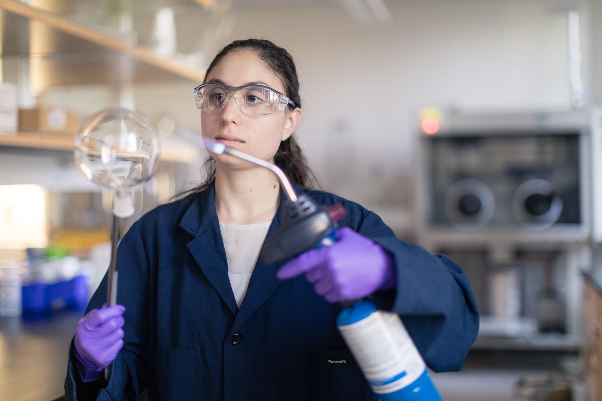 A student sanitizes a test tube.