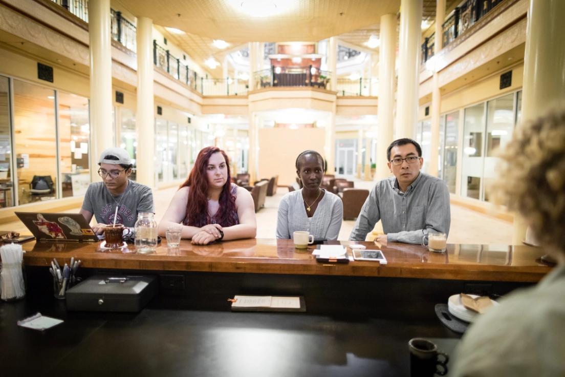 Dr. Peng and his students sitting at the bar at Downtown Credo.