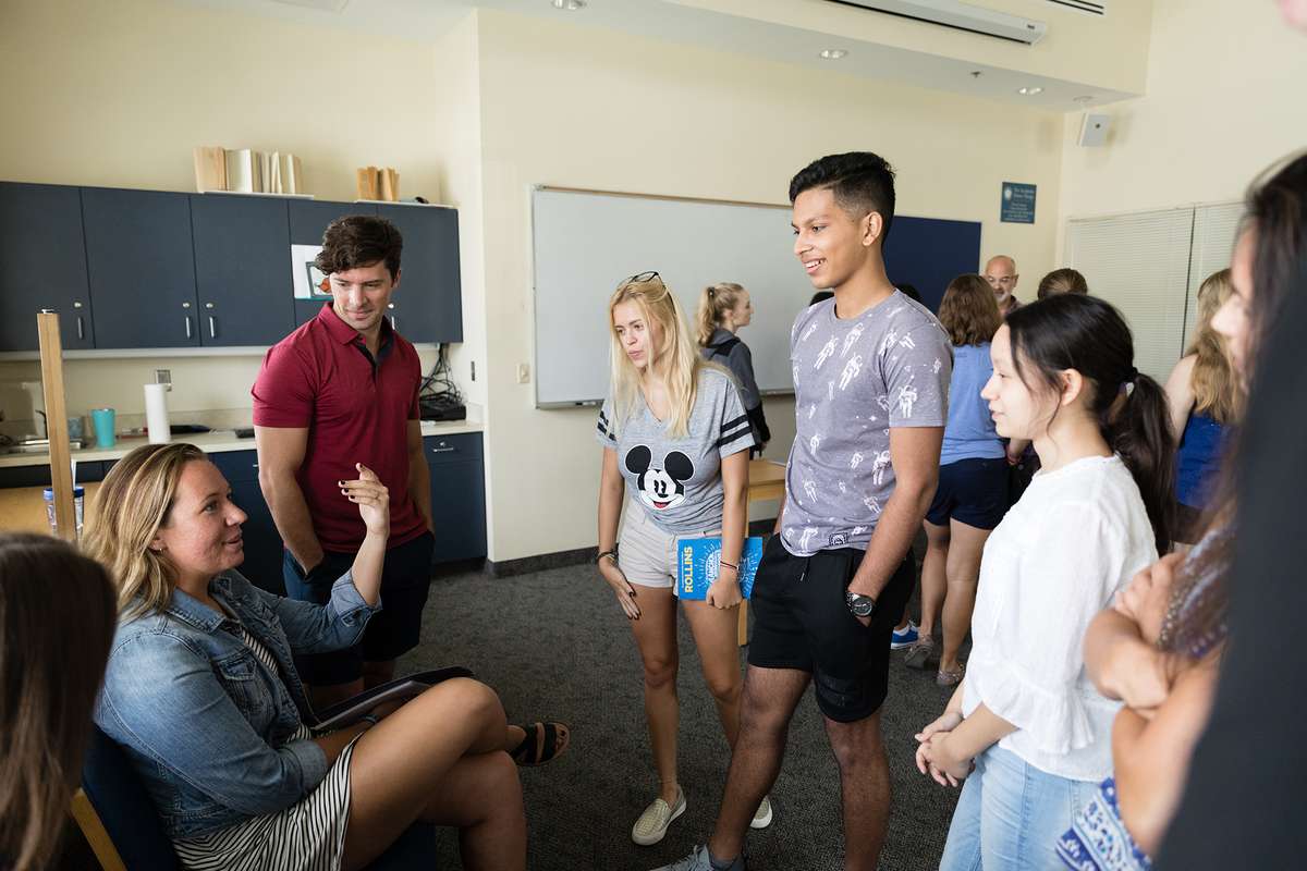 A circle of students have a discussion during a first-year college class.