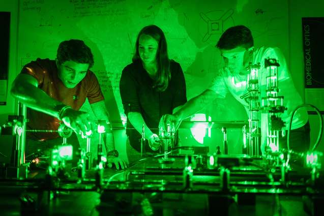 Students researching lasers for a physics lab.