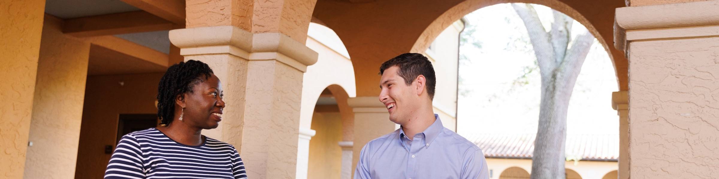 A group of Rollins College faculty gather at a table.