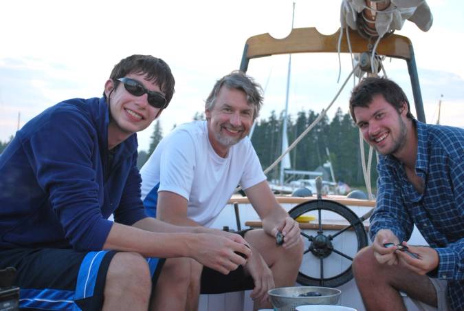 Grant Cornwell and sons enjoying mussels on the water in Maine.